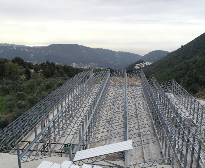 Steel greenhouse structures on a Lebanese hillside
